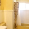 Yellow tub and toilet updated yellow and grey bathroom