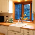 beadboard-kitchen-cabinet-doors-with-butcher-block-counters-subway-tile-backsplash