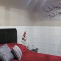 remodelaholic-remodeling-master-bedroom-wainscotting-red (570x280)