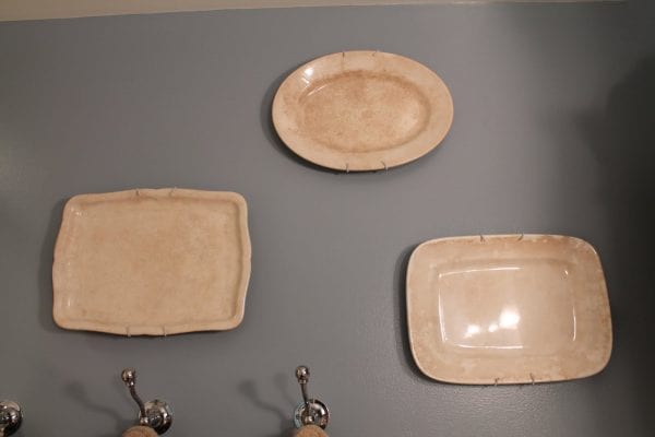 18 Ironstone platters on the wall, by Elizabeth and Co featured on @Remodelaholic