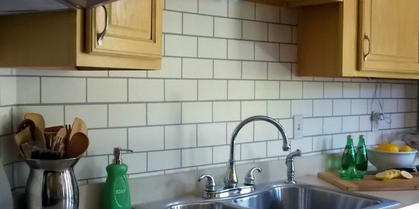 faux painted subway tile kitchen backsplash sink feature
