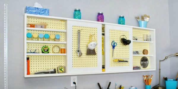 pegboard tool cabinet with sliding doors, featured on Remodelaholic.com