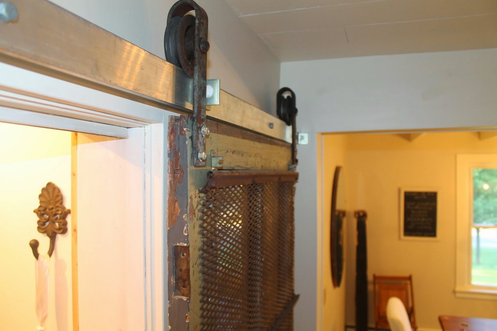 sliding barn door for pantry using old meat hooks, Girl Meets Carpenter on @Remodelaholic