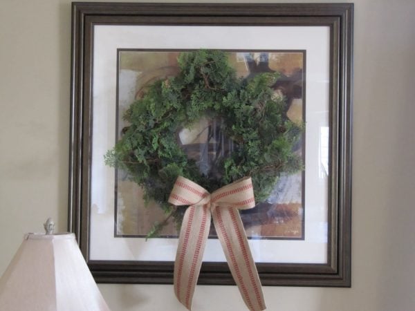 hang a wreath on framed art - Sew Many Ways via @Remodelaholic