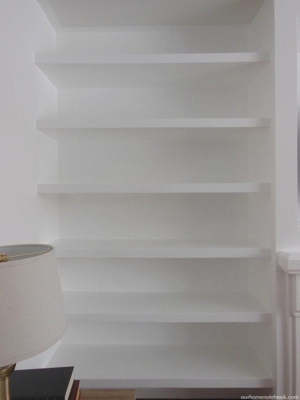 Creating a TV and Fireplace Built In with Floating Shelves by Our Home Notebook featured on Remodelaholic