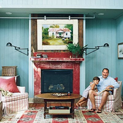 canvas art frame on a rail to hide the television (Southern Living)