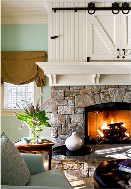 hidden television behind barn doors in a mantel (Crisp Architects)