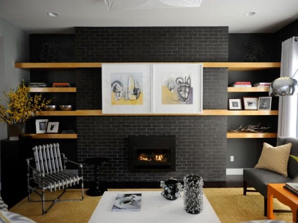 sliding artwork on floating shelves to cover the television (HGTV)