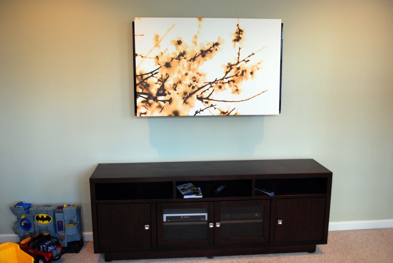 Remodelaholic 95 Ways To Hide Or Decorate Around The Tv Use An Art Canvas To Cover A Television Tulipandturnip