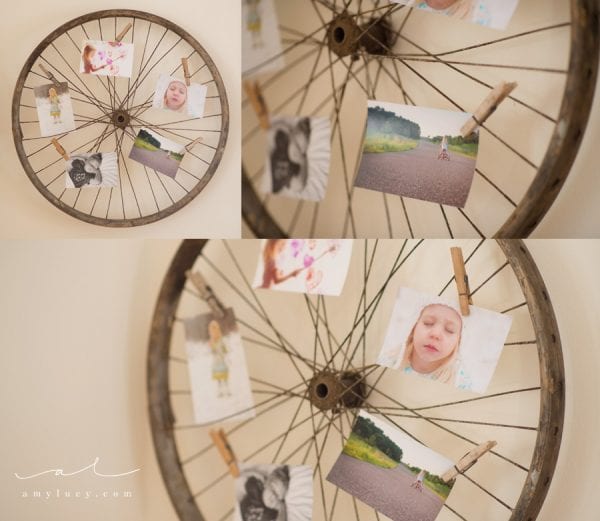 use an old bike wheel to display photos and art prints (Amy Lucy)
