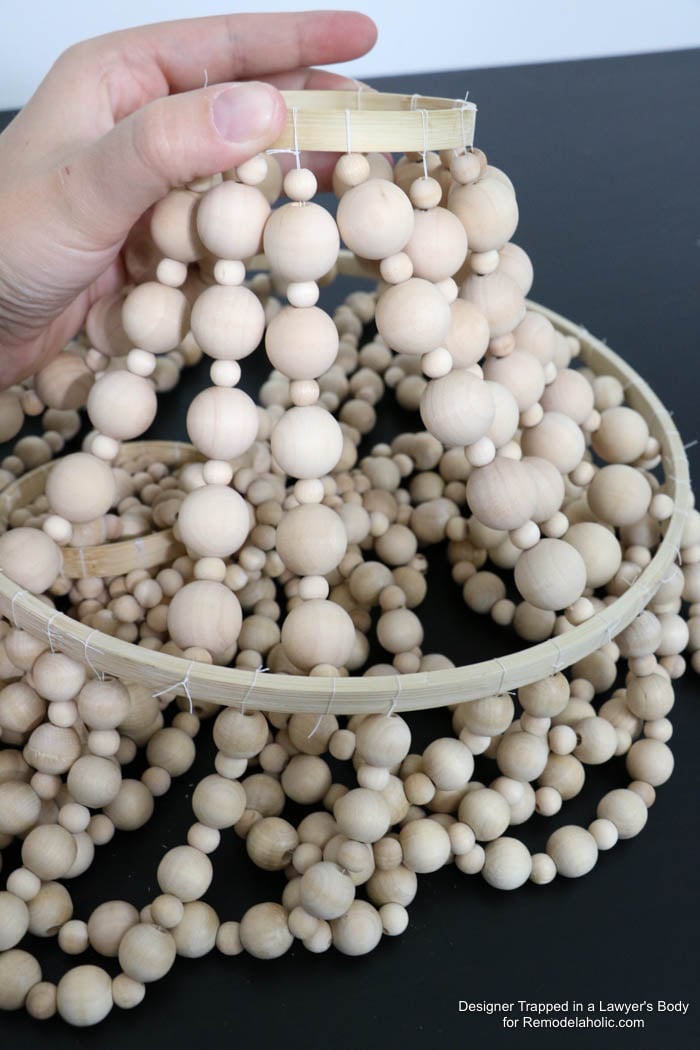 WOW! Come learn how to make your own wood bead chandelier with this awesome tutorial by Designer Trapped in a Lawyer's Body for Remodelaholic.com!