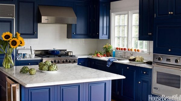 Cobalt blue kitchen with marble countertops via House Beautiful
