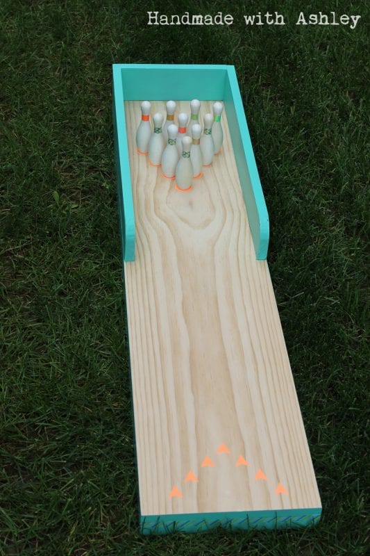 15 DIY bowling lane and pins made of scrap wood and finished with washi tape, Handmade by Ashley featured on @Remodelaholic
