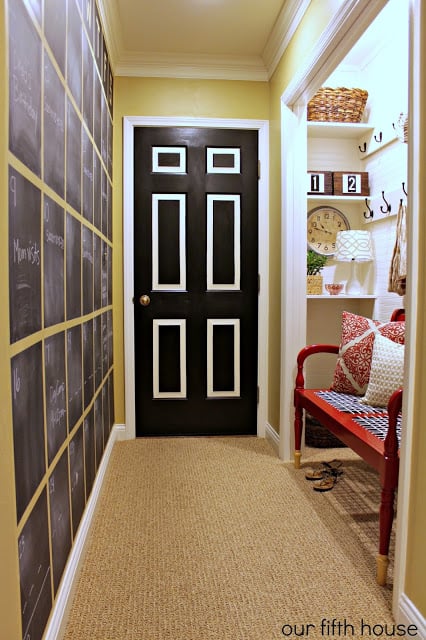Mudroom Hallway, closet turned mudroom plus chalkboard calendar on the wall | 100+ Beautiful Mudrooms and Entryways at Remodelaholic.com