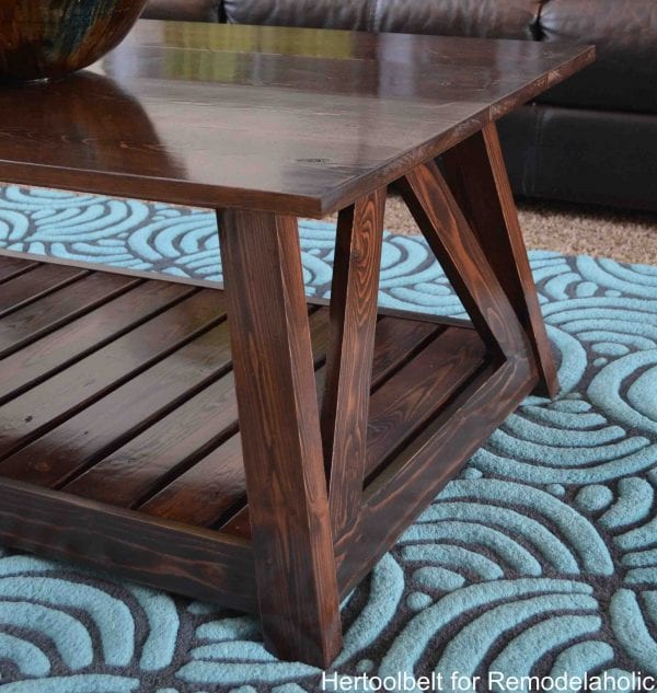 Inspired by a coffee table in a HGTV dream home. I love the trapezoid base and slats that make up this table. DIY slat coffee table with free plans.