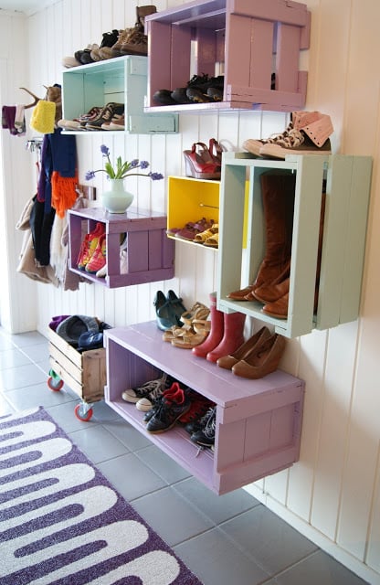 Such a great entryway, colorful crates hung on the wall for shoe storage | 100+ Beautiful Mudrooms and Entryways at Remodelaholic.com