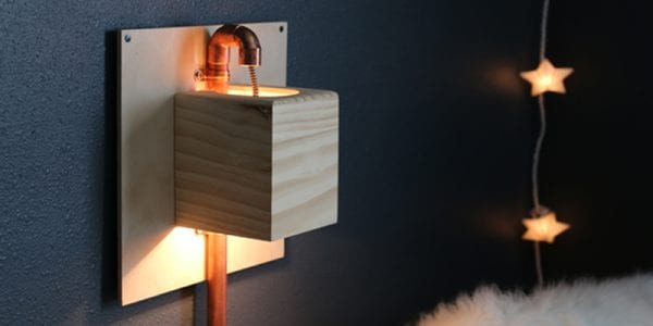 Make this industrial modern, apartment friendly DIY wall sconce with the simplest of materials!