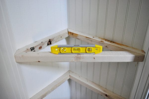 how to install custom triangle floating shelves in a hall closet organization project