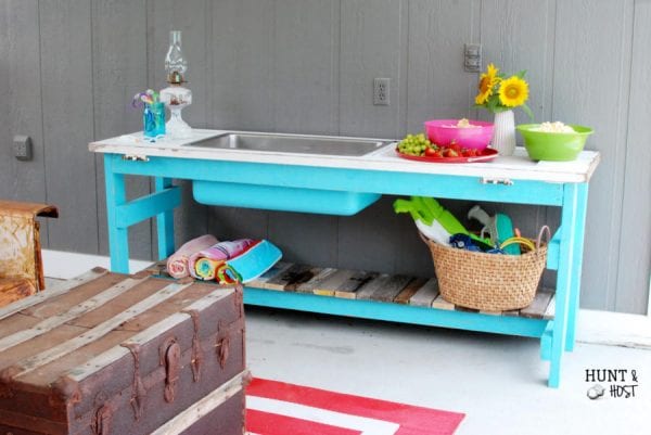 Upcycled wooden door and kitchen sink make a stunning poolside table by Hunt and Host featured on @Remodelaholic
