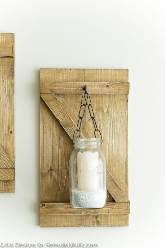 Bring the rustic farmhouse style home with this easy and inexpensive mason jar candle holder or vase. It's easy to make your own hanging mason jar!