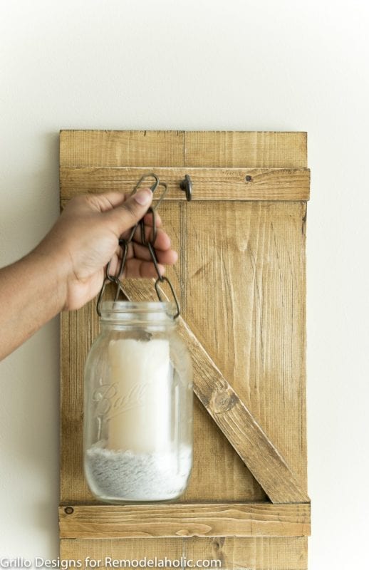 Bring the rustic farmhouse style home with this easy and inexpensive mason jar candle holder or vase. It's easy to make your own hanging mason jar!