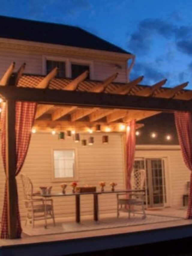 Pergola With Hanging String Lights Curtains And Dinner Table Shown At Night