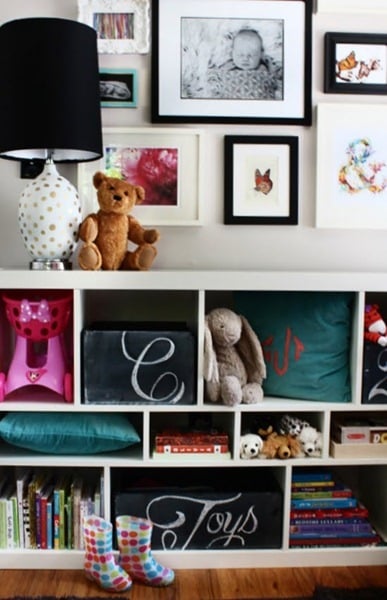 Toy Room Shelves With Chalkboard Toy Box Storage And Colorful Books, Pillows, Toys, Pictures On Wall And Rainboots