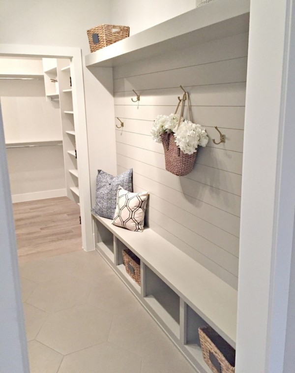 Gorgeous Grey And White Mudroom Area With Shiplap Wall, Hooks, Cubbles, A Bench And Shelf