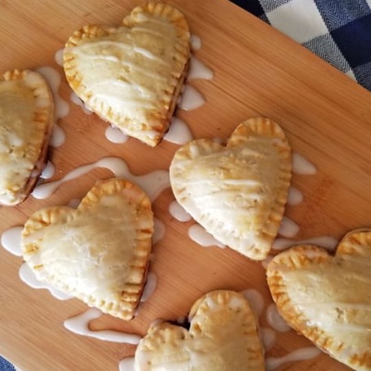 Beautiful Individual Heart Shaped Blackberry Pies, Mini Pies, With Frosing Drizzled On Top