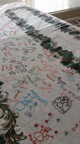 Christmas Tablecloth With Cross Stitch Signatures Added To It