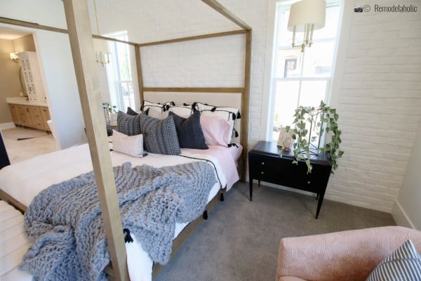Pretty natural wood four poster upholstered bed in a pretty master bedroom, UVPH 2018 Home 17 Millhaven Homes, Four Chairs Furniture & Design, Photo by Remodelaholic