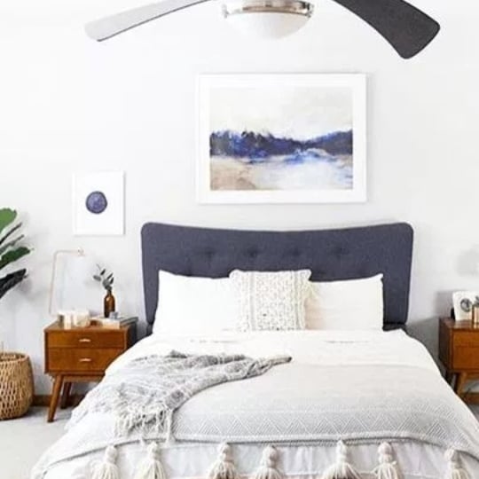 White And Blue Bedroom, Blue Headboard, White Bedding, Wood Side Tables And Blue And White Artwork On The Walls